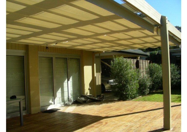 Custom retractable patio awning extended over a timber deck to provide shade and UV protection in Melbourne.