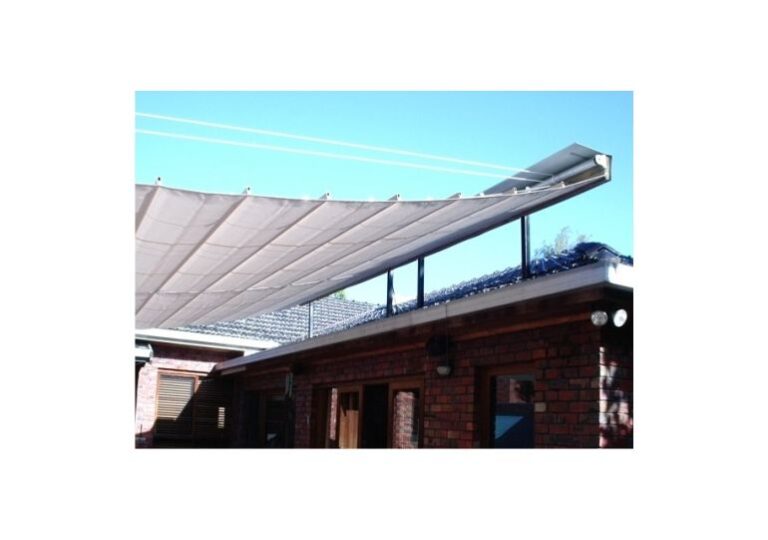 White retractable awnings installed above a brick home patio to provide shade over outdoor entertaining areas in Melbourne.