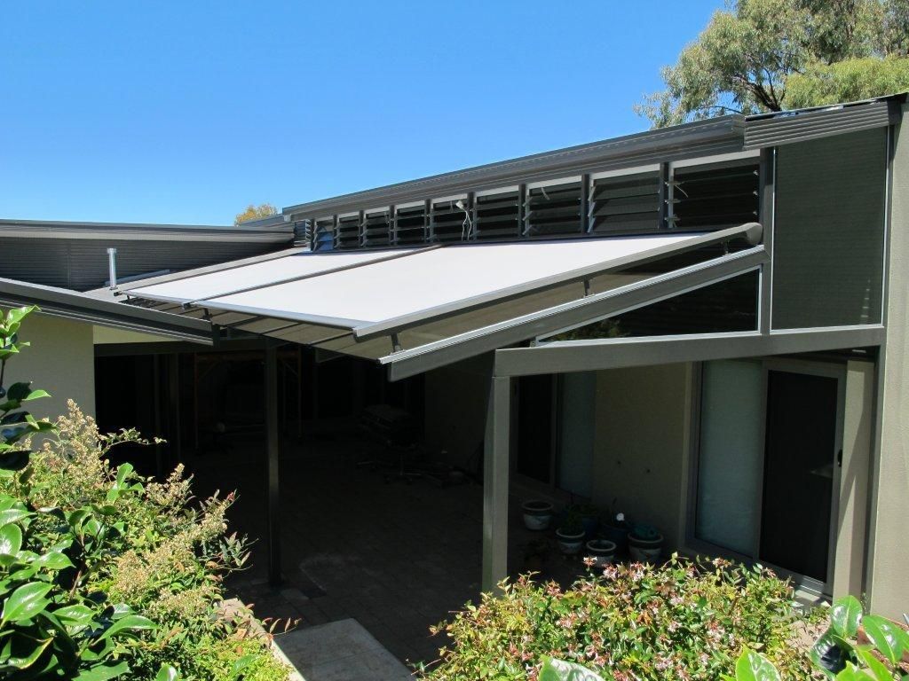 Motorised retractable pergola roof system providing UV shade over Melbourne outdoor entertaining space